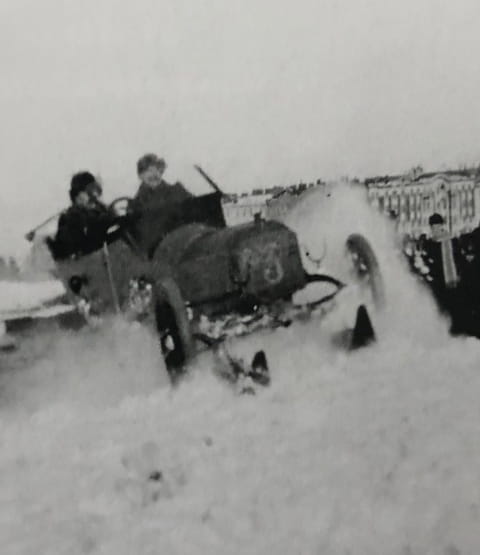 two people in kegresse car on snow