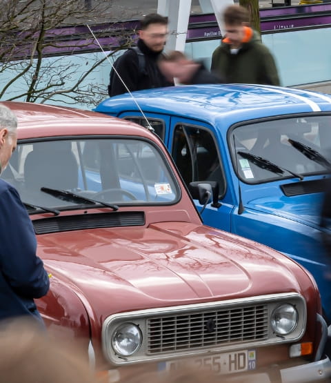 Image with the FNVE logo showing a gathering of 4L cars of different colours with people who have come to admire them.