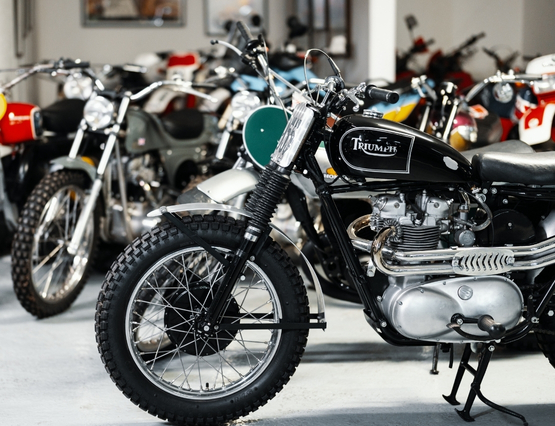 photo of a black Triumph with other motorcycles in the background