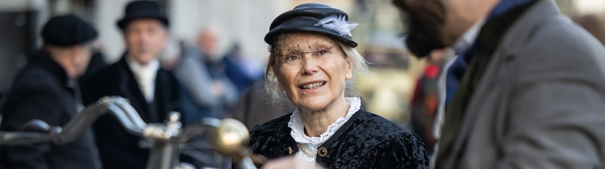 close-up of a old woman face with people