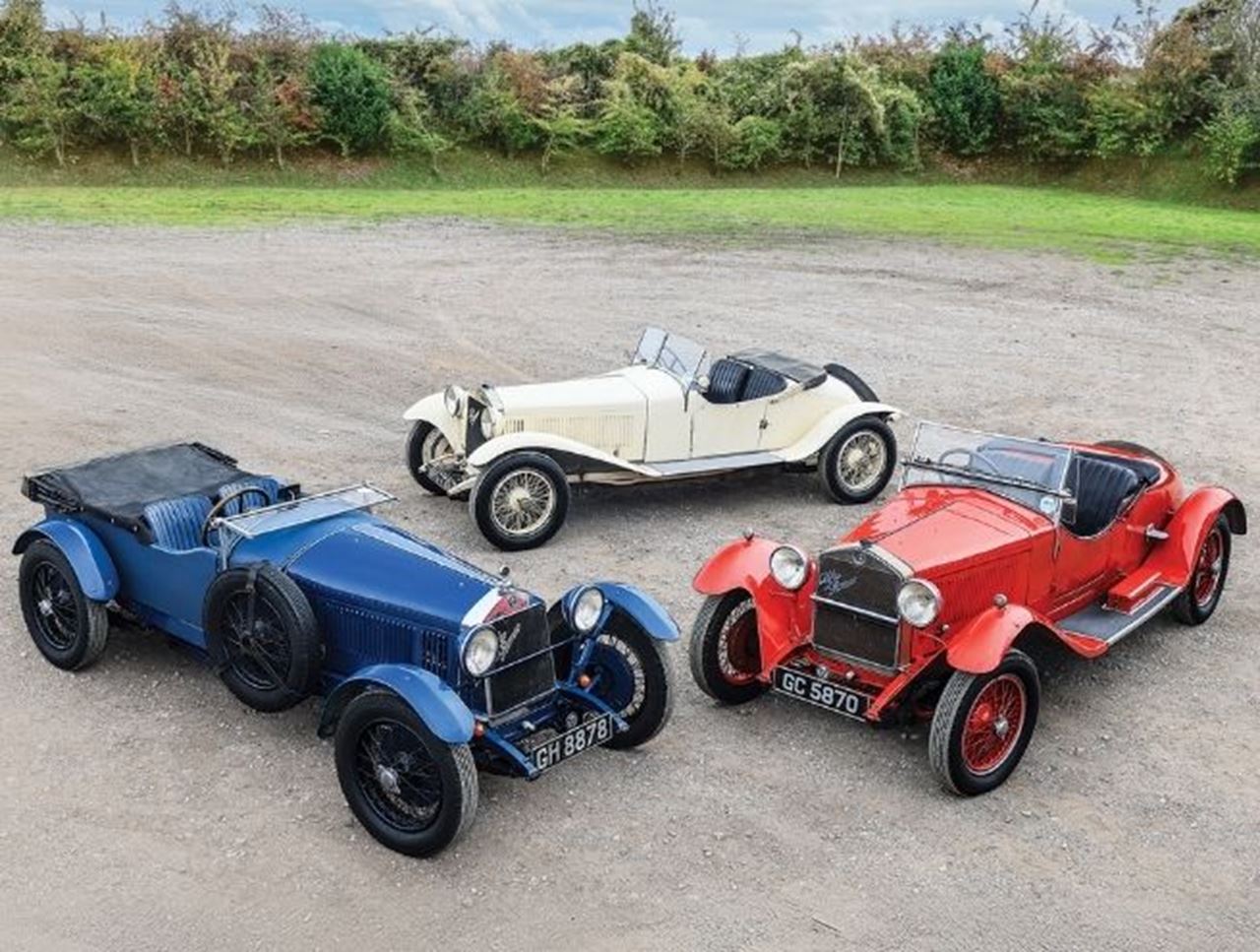 Top view image showing three blue, white, and red vintage cars