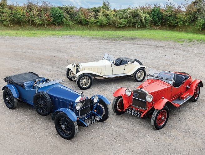 Top view image showing three blue, white, and red vintage cars